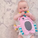Baby wearing the Snuggle Monster band on chest, holding the teether