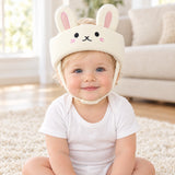 TummyHush Soft Landing Cap — padded head cap worn by a baby, Bunny