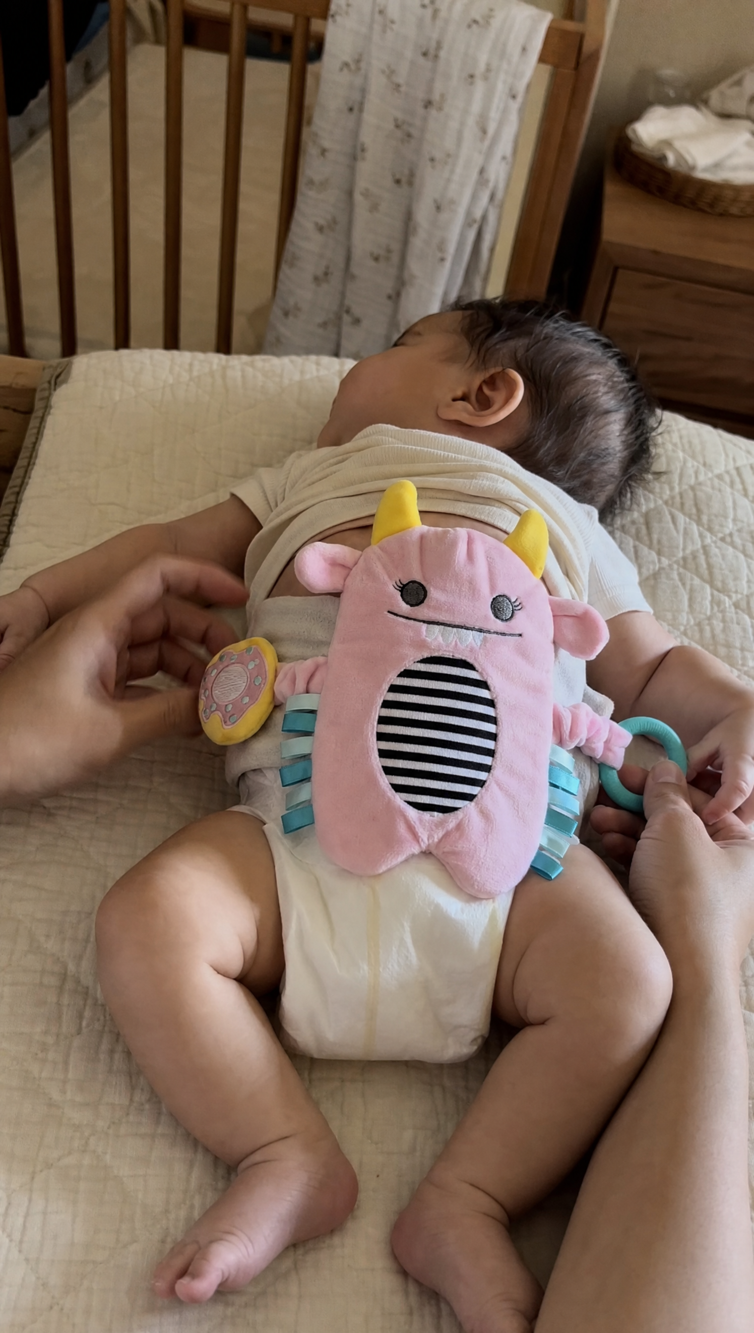 Parent placing Snuggle Monster band on baby