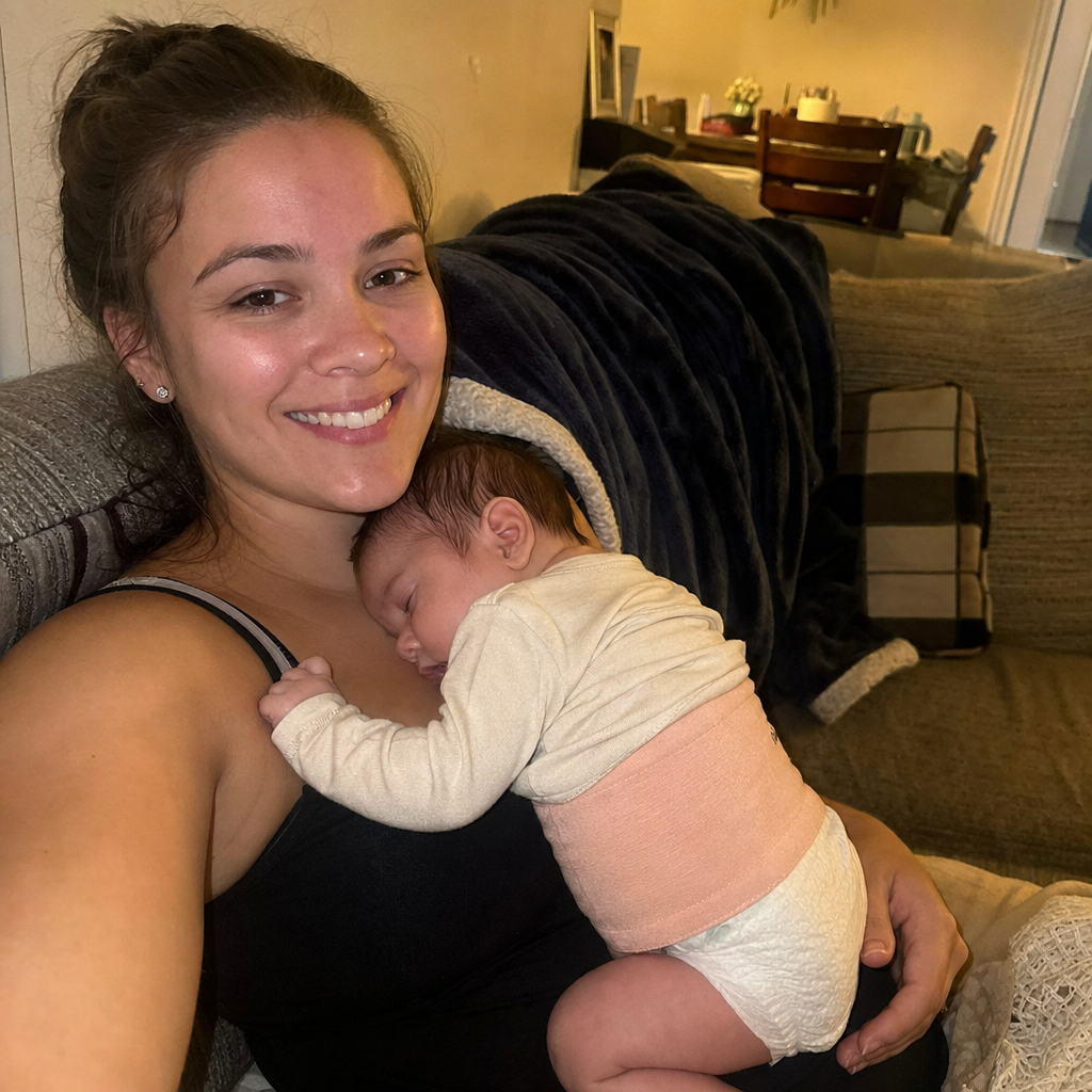 Mom calming baby with the belly band on